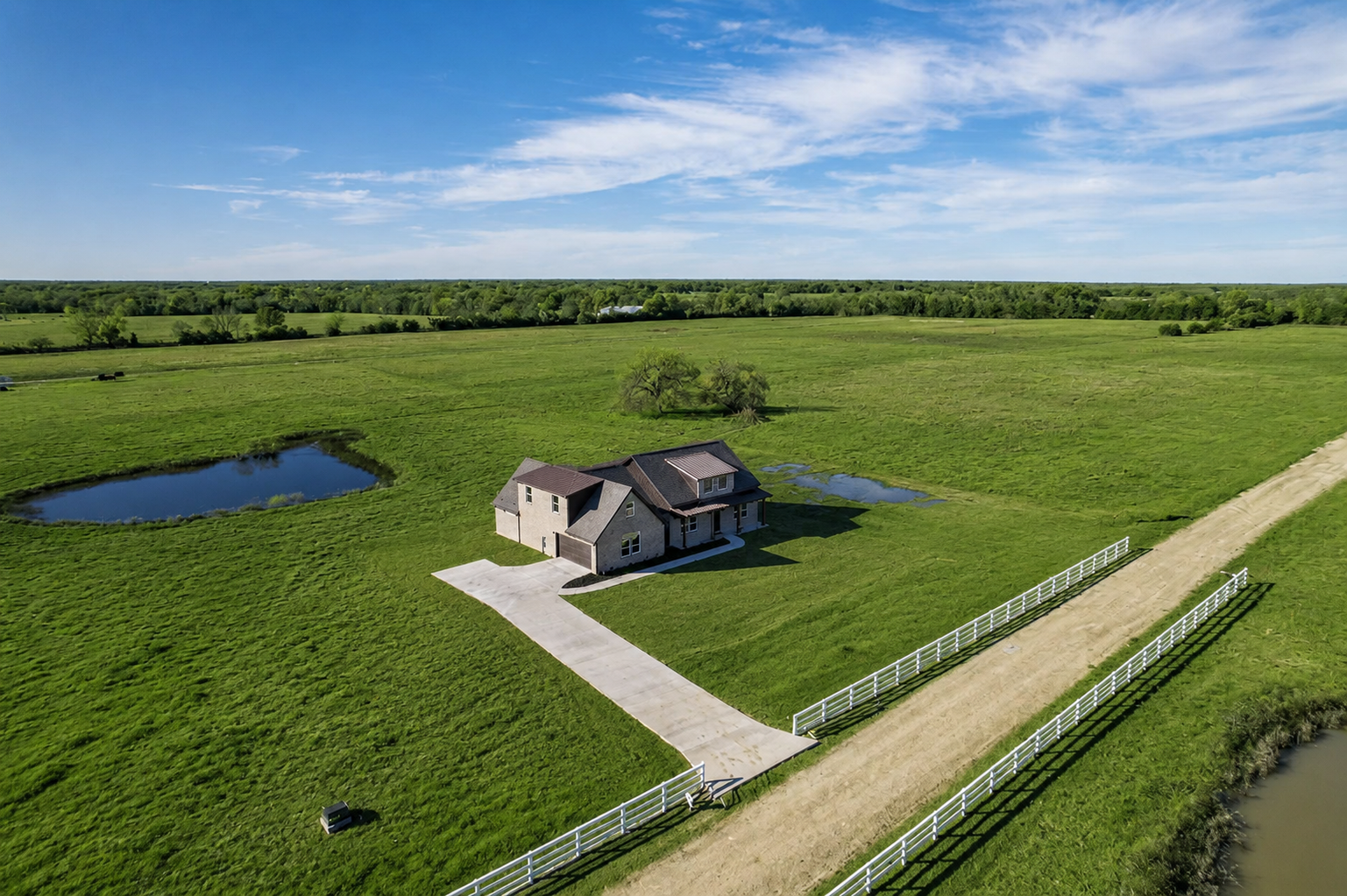 Aerial view of a custom home on a large rural property